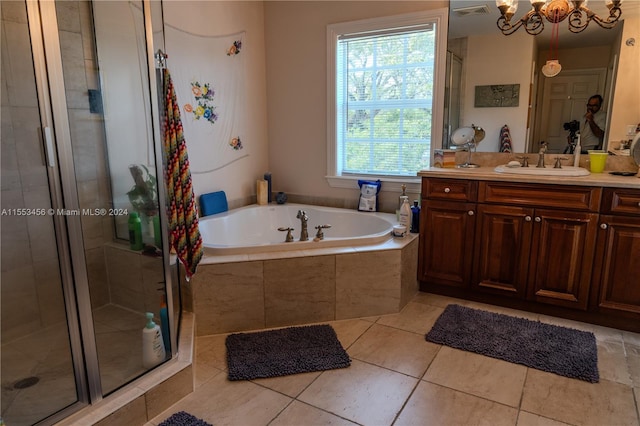 bathroom featuring plus walk in shower, a chandelier, tile flooring, and vanity with extensive cabinet space