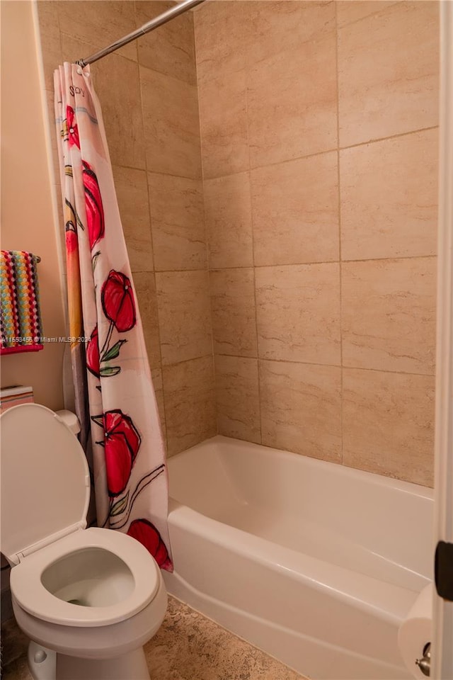 bathroom with toilet, tile floors, and shower / tub combo with curtain