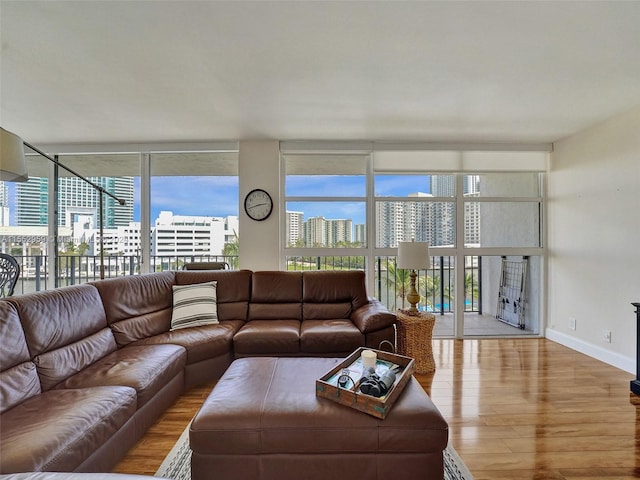 living room with floor to ceiling windows and light wood-type flooring