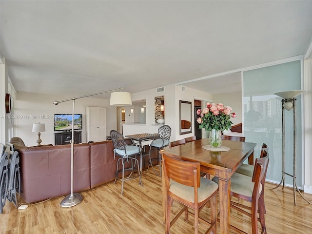 dining area with light hardwood / wood-style flooring