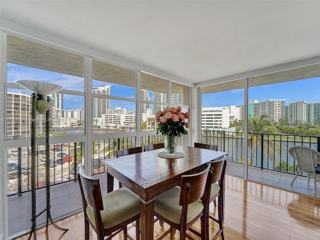 sunroom featuring a water view