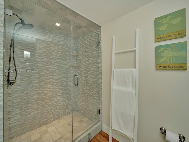 bathroom with a shower with door