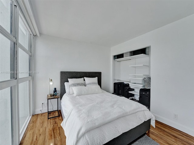 bedroom with a closet and light hardwood / wood-style flooring