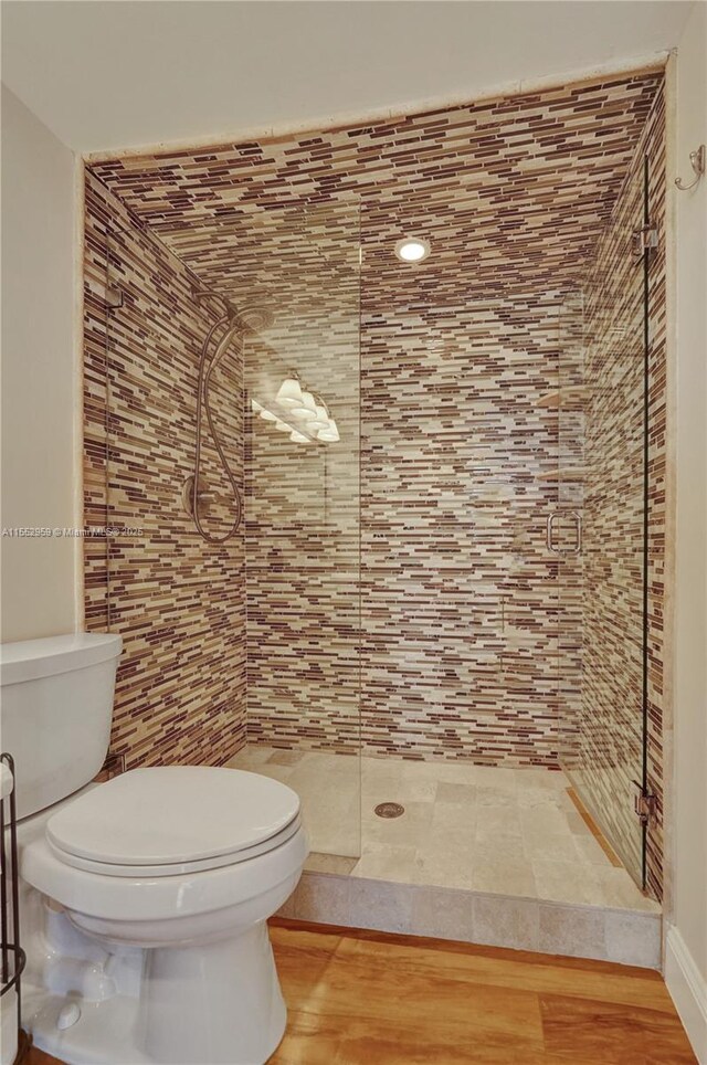 foyer entrance with light hardwood / wood-style floors and stacked washing maching and dryer