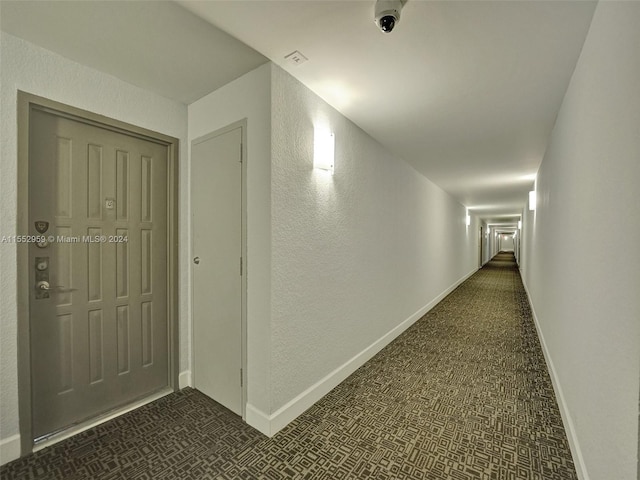 corridor with dark tile floors