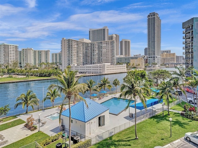 view of swimming pool with a water view and cooling unit