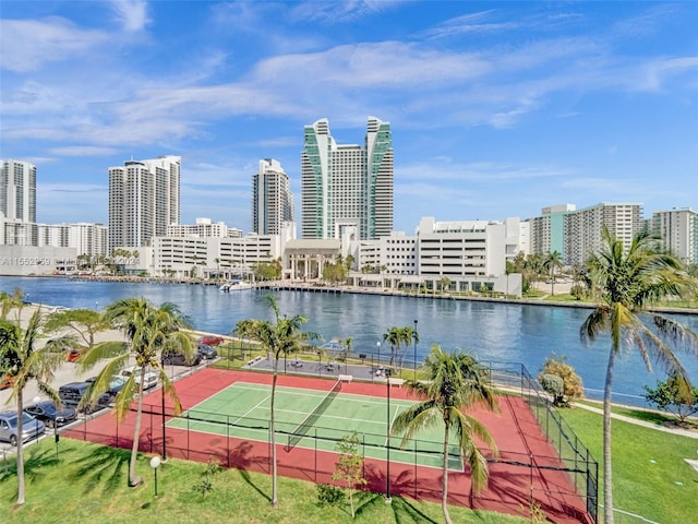 view of tennis court with a water view