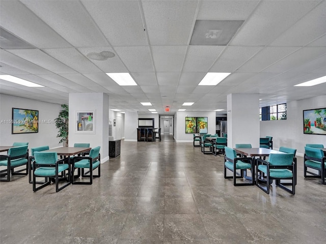 interior space featuring tile floors and a drop ceiling