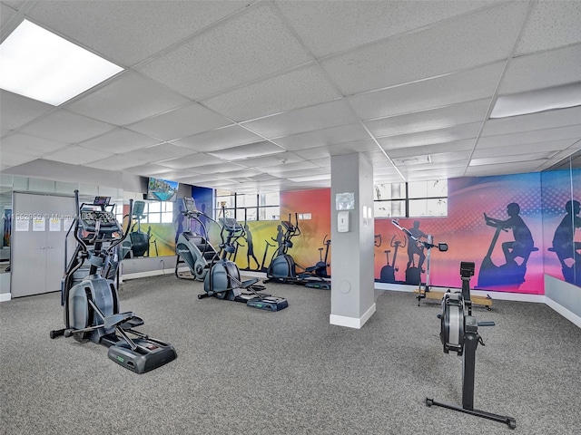 workout area featuring a paneled ceiling and carpet floors