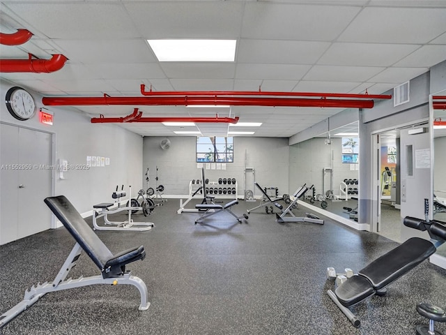 gym with a paneled ceiling