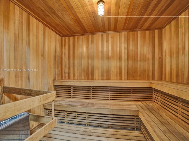 view of sauna / steam room featuring wooden walls and wooden ceiling