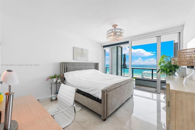 tiled bedroom featuring expansive windows, access to exterior, and a water view