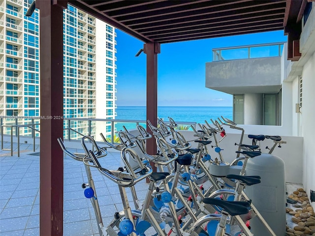 view of patio / terrace with a balcony and a water view