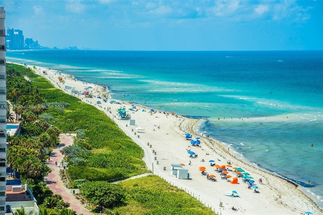 aerial view with a water view and a beach view