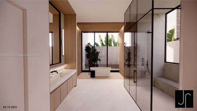 bathroom featuring a shower with shower door and sink