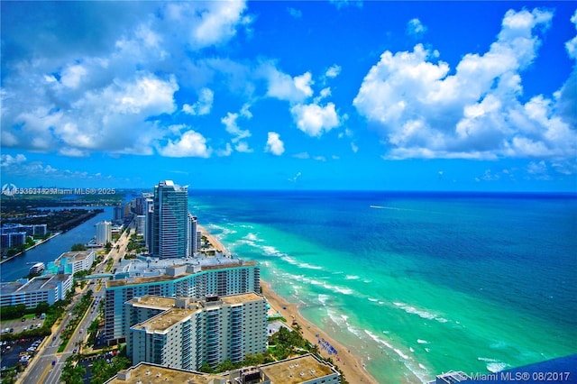 birds eye view of property with a water view and a view of the beach