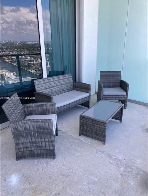 patio terrace at dusk with a balcony and an outdoor living space