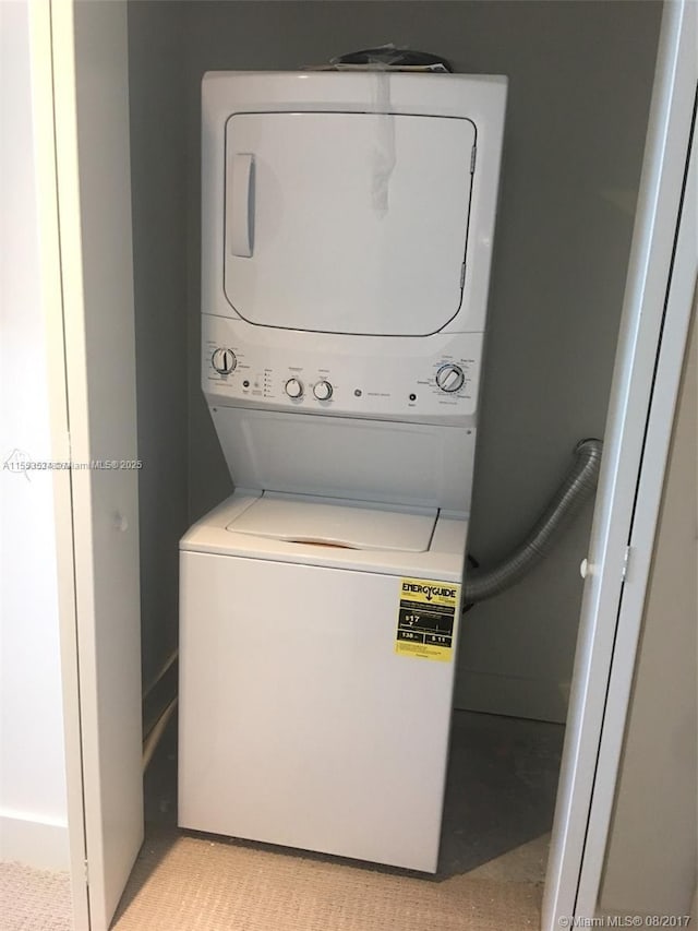 laundry area with stacked washer and dryer