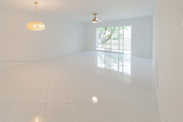 empty room featuring light tile patterned floors and ceiling fan