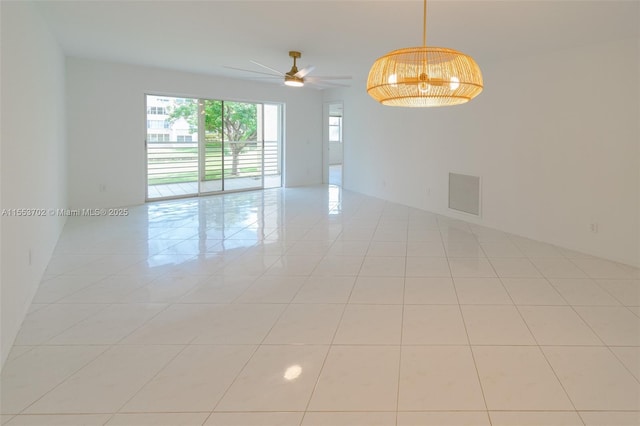 tiled empty room with ceiling fan