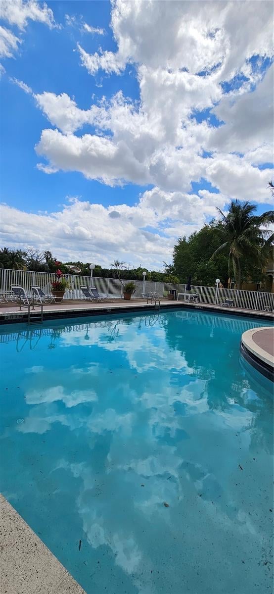 view of pool with a community hot tub and a patio