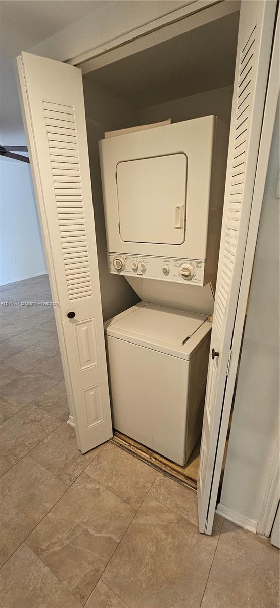 laundry room featuring stacked washer and clothes dryer and laundry area