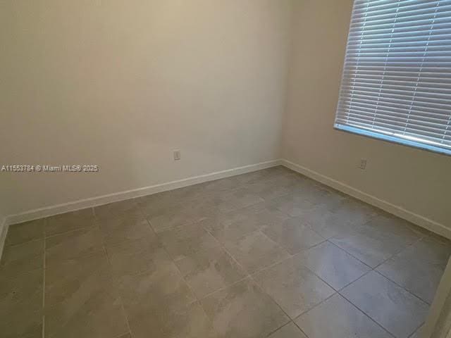 empty room featuring light tile patterned floors