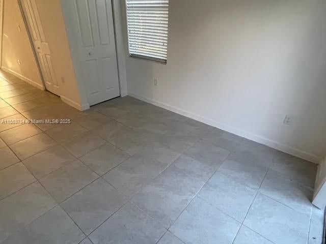 unfurnished bedroom with light tile patterned floors