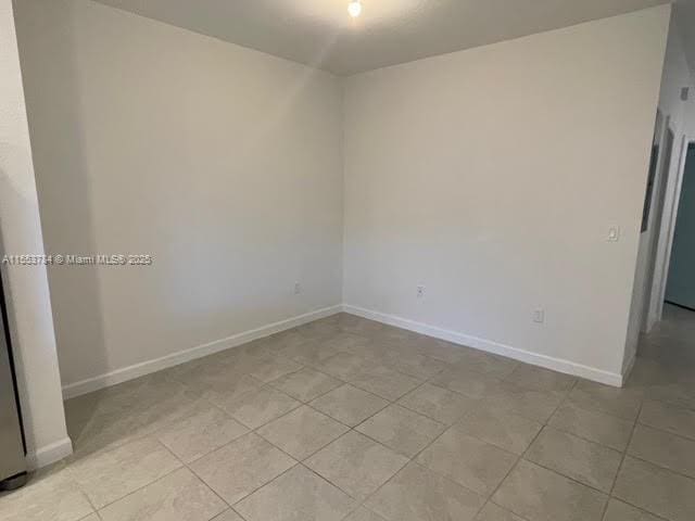 empty room with light tile patterned floors