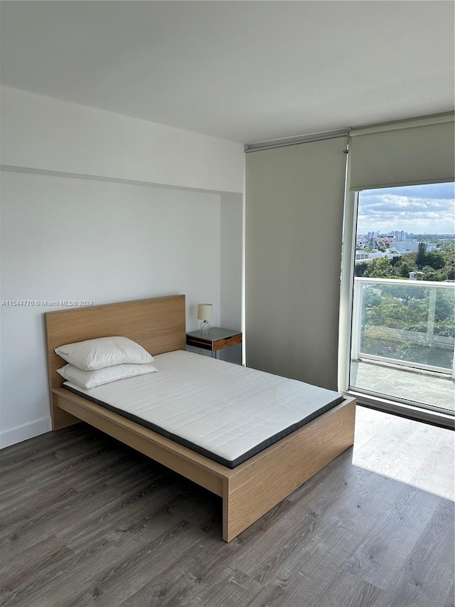 bedroom with dark hardwood / wood-style floors