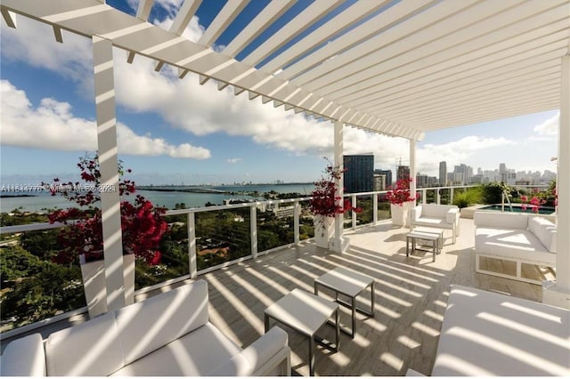 view of patio / terrace featuring a water view, a pergola, and an outdoor living space