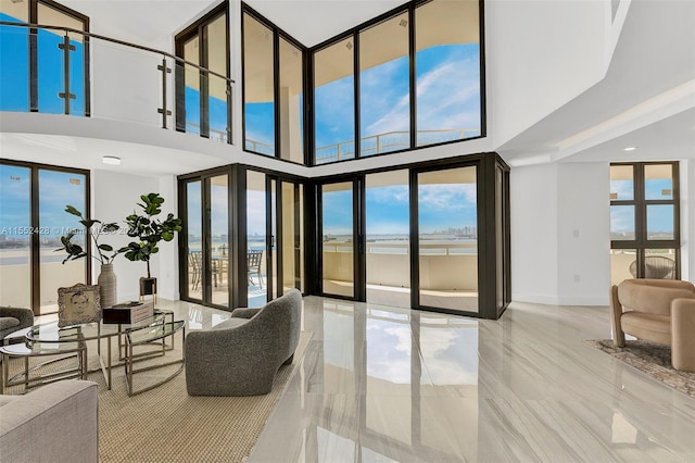 living room featuring light tile flooring and a towering ceiling