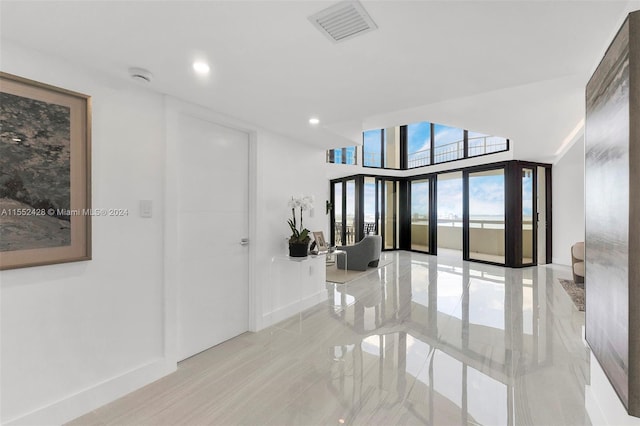 corridor featuring light tile floors