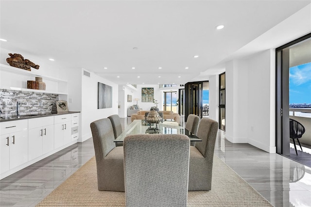 tiled dining room featuring a healthy amount of sunlight