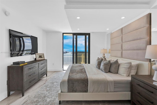 bedroom with floor to ceiling windows, light hardwood / wood-style floors, and access to outside