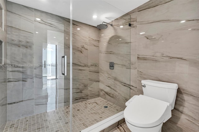 bathroom featuring walk in shower, tile walls, and toilet