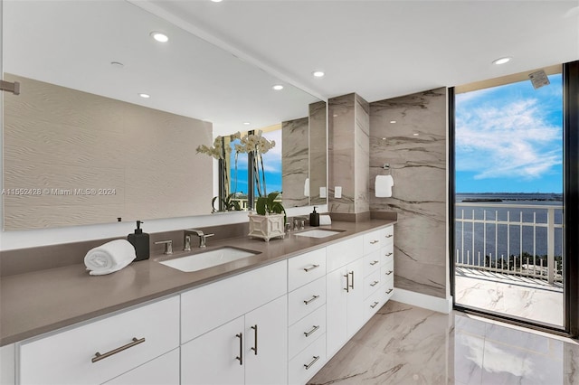 bathroom featuring dual bowl vanity, a water view, and tile flooring