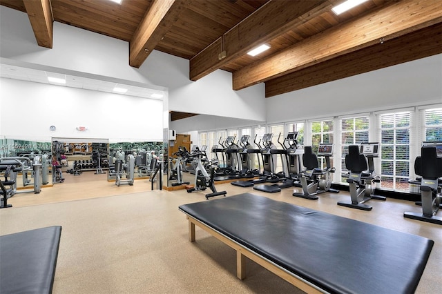 gym featuring wood ceiling and a towering ceiling