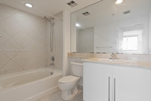 full bathroom with tiled shower / bath, toilet, tile floors, and oversized vanity