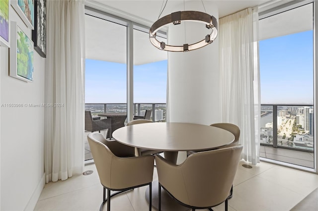 tiled dining space with a wall of windows and an inviting chandelier