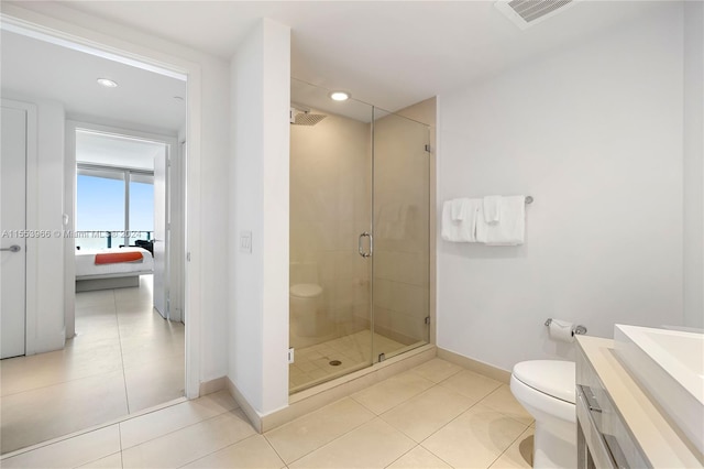 bathroom featuring an enclosed shower, vanity, tile flooring, and toilet