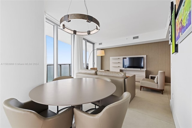 dining space with an inviting chandelier and expansive windows