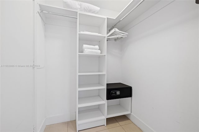 spacious closet featuring light tile floors