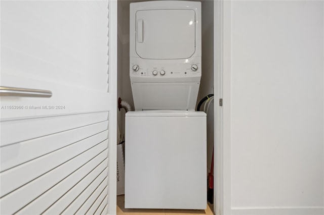 laundry room with stacked washer / dryer