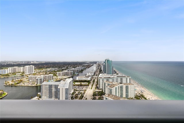 birds eye view of property with a water view and a view of the beach