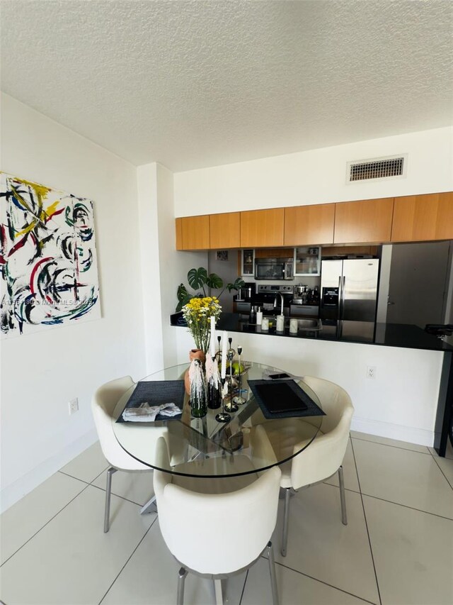 full bathroom with stacked washing maching and dryer, tiled shower / bath, tile patterned flooring, vanity, and toilet