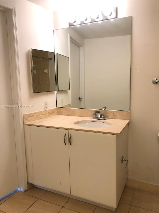 bathroom with tile patterned floors and vanity