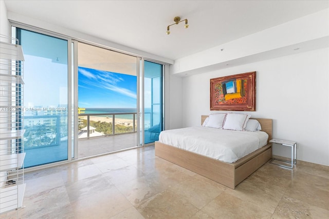 bedroom with light tile floors, access to outside, and expansive windows