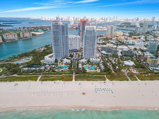 drone / aerial view featuring a water view and a view of the beach