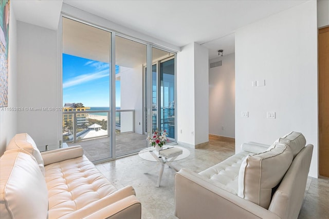 living room featuring a water view and expansive windows